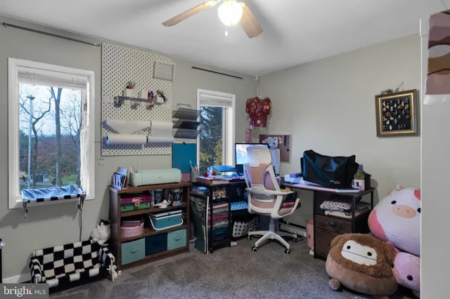 a bedroom with a bed next to a window and a mirror