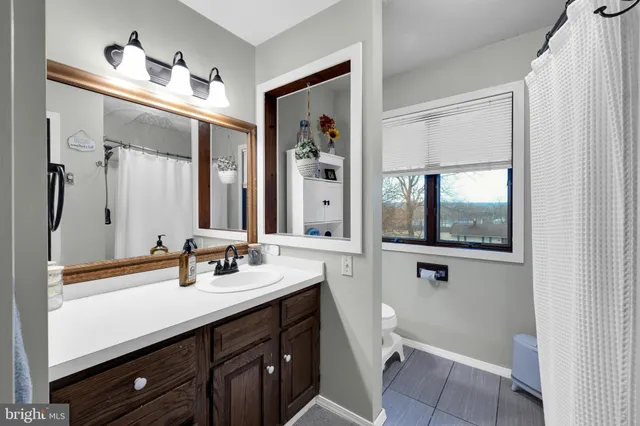 a bedroom with a bed and a flat tv screen on wall