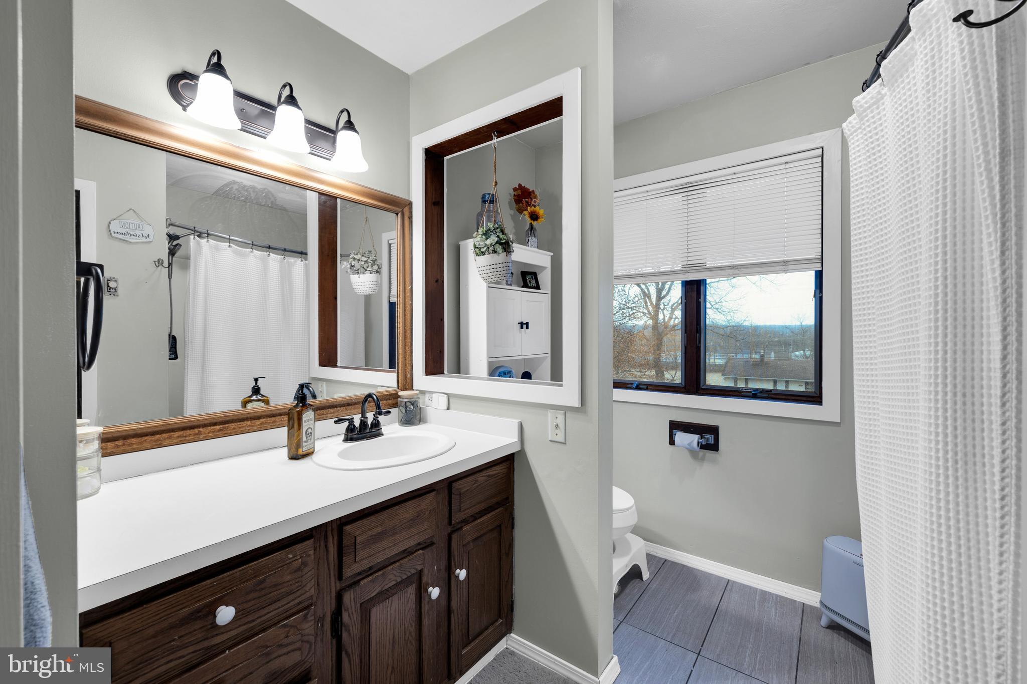 111 Kohler Road Kutztown, PA 19530 - Photo 17 of 19 a bathroom with a sink a toilet and a mirror