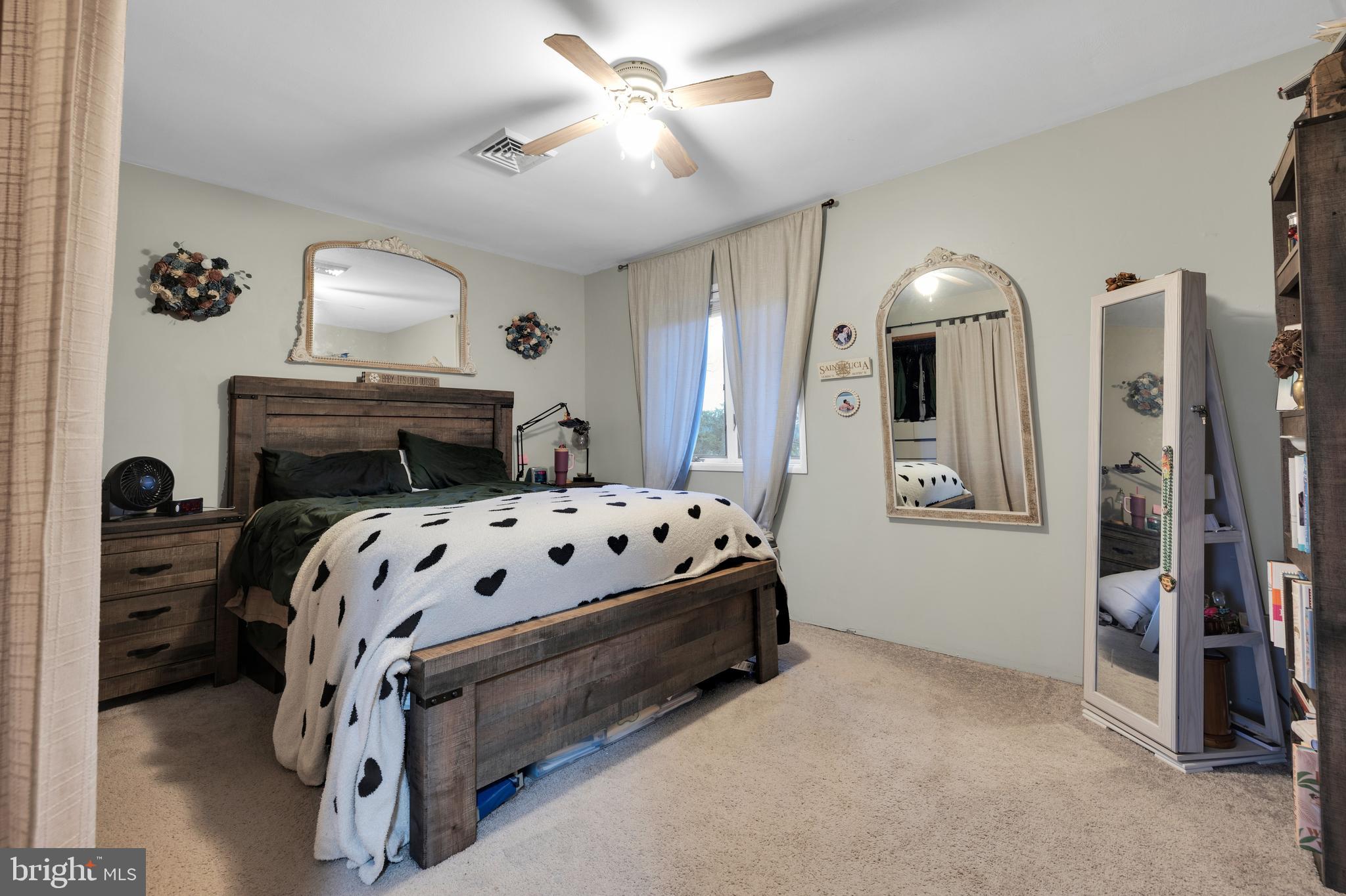111 Kohler Road Kutztown, PA 19530 - Photo 18 of 19 a bedroom with a bed next to a window and a mirror