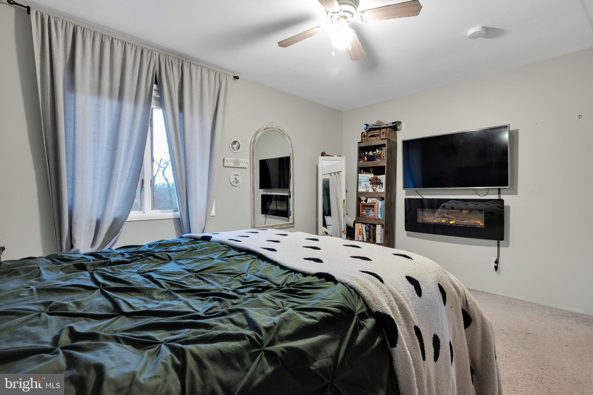 111 Kohler Road Kutztown, PA 19530 - Photo 19 of 19 a bedroom with a bed and a flat tv screen on wall