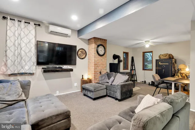 a living room with furniture and a lamp
