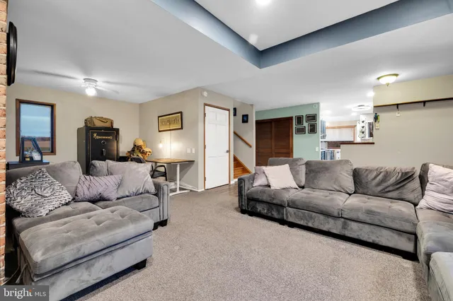 a kitchen with kitchen island granite countertop wooden cabinets and a stove top oven