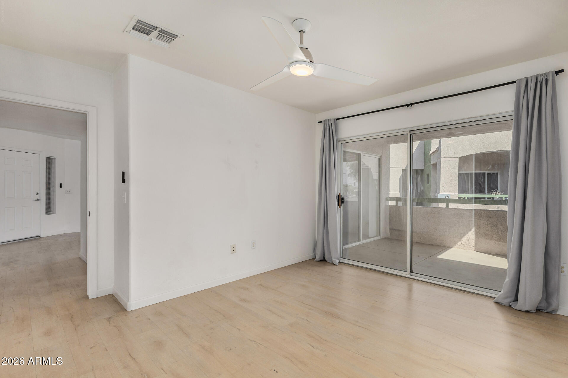 1295 North Ash Street, Unit 828 Gilbert, AZ 85233 - Photo 13 of 43 a view of an empty room with a glass door