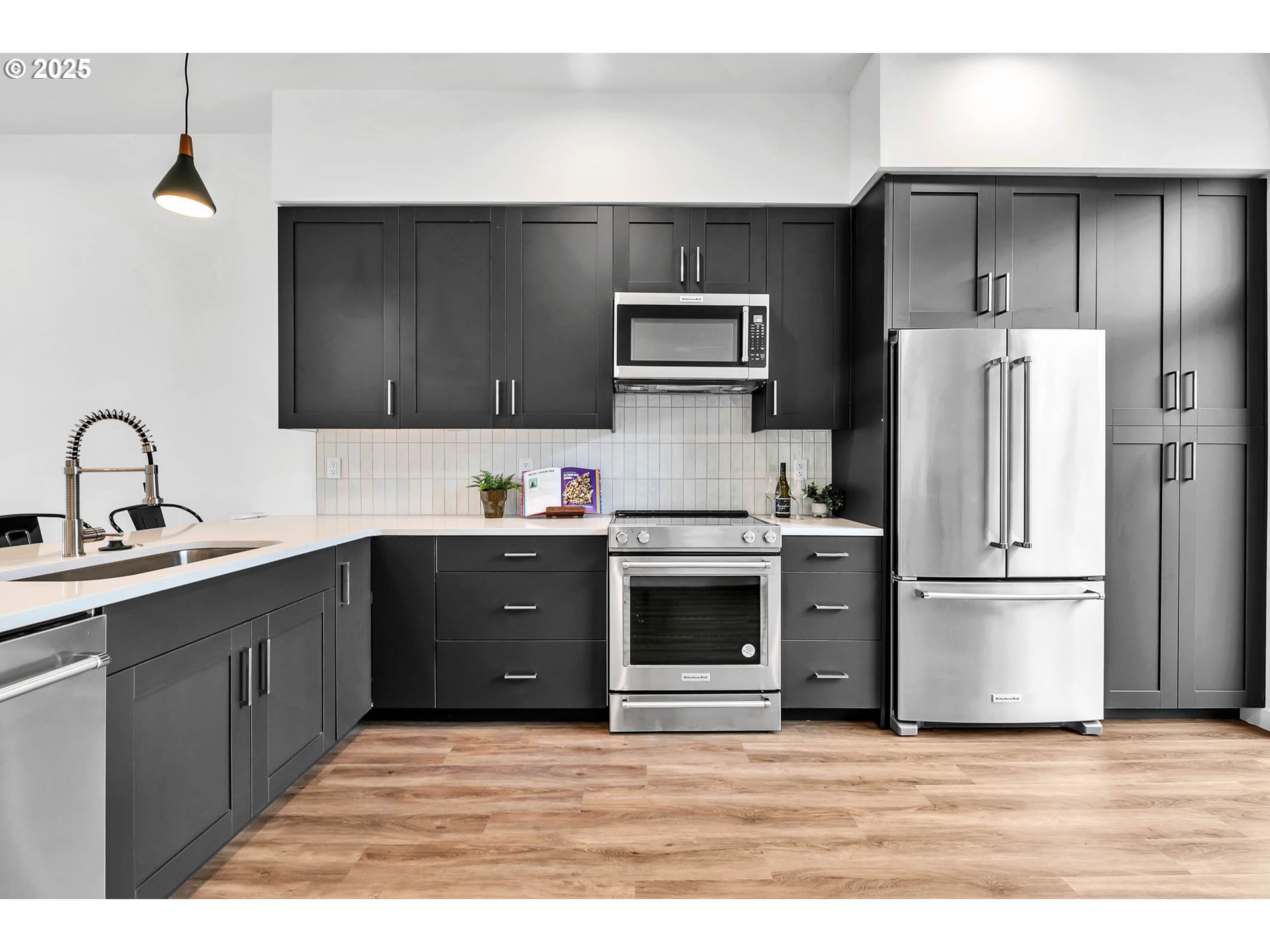 177 East 20th Avenue Eugene, OR 97405 - Photo 14 of 45 a kitchen with stainless steel appliances a stove a sink a refrigerator and cabinets