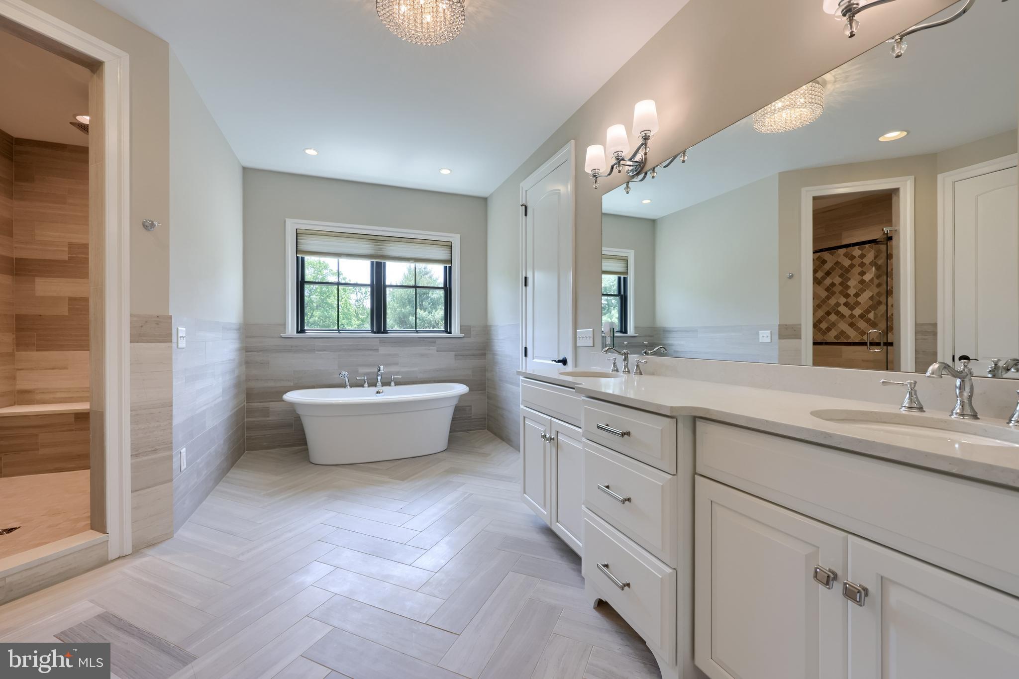 428 Southampton Drive Lititz, PA 17543 - Photo 38 of 60 a spacious bathroom with a double vanity sink large mirror and a bathtub