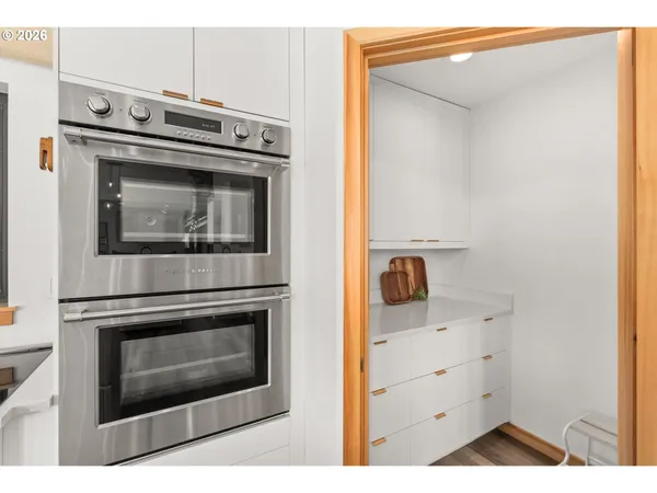 a stove top oven sitting inside of a kitchen