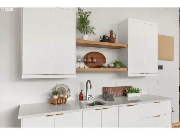 a kitchen with white cabinets and a sink