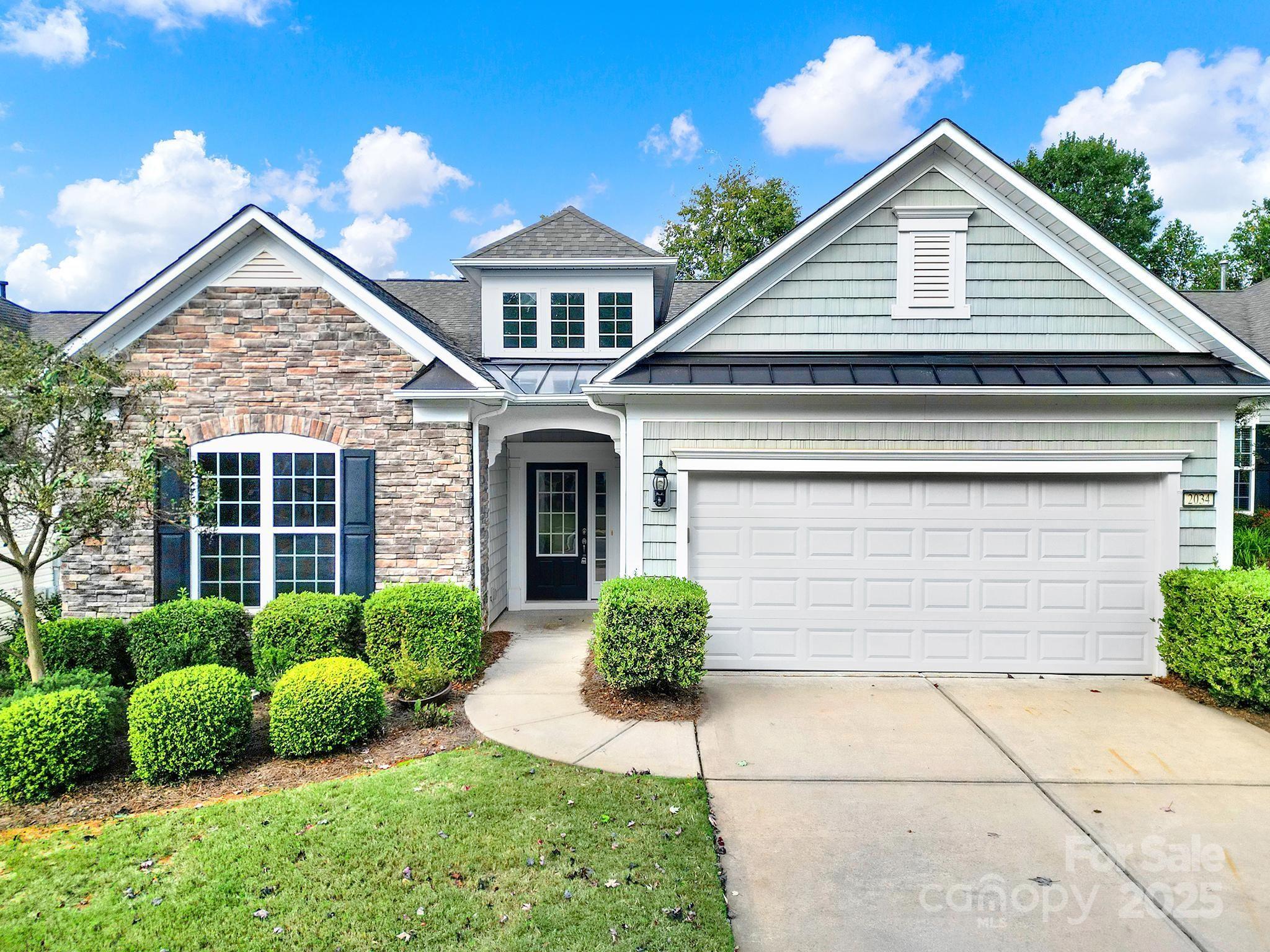 2034 Moultrie Court Fort Mill, SC 29707 - Photo 1 of 46 a front view of a house with garden