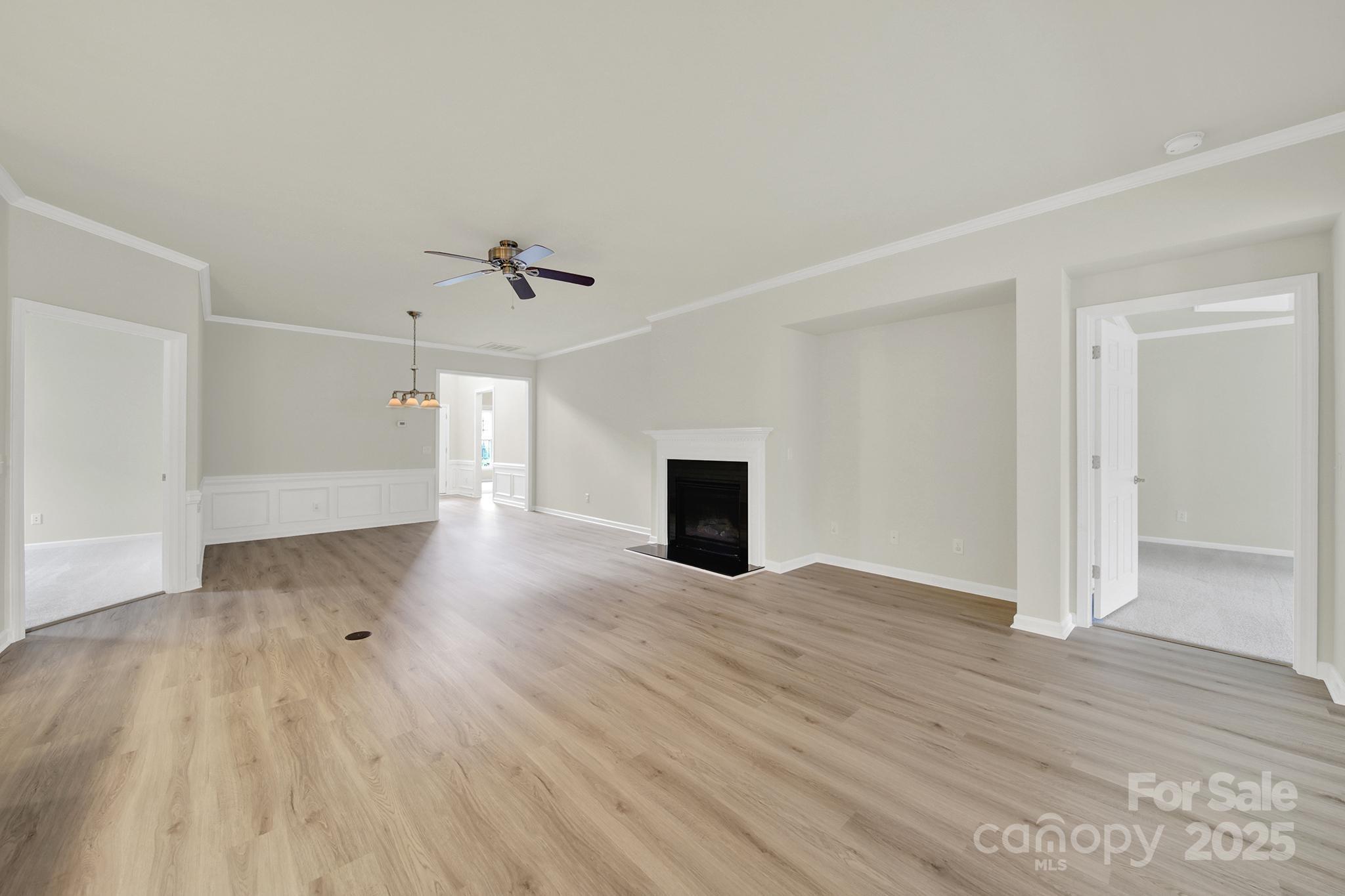 2034 Moultrie Court Fort Mill, SC 29707 - Photo 13 of 46 wooden floor in an empty room with a fireplace