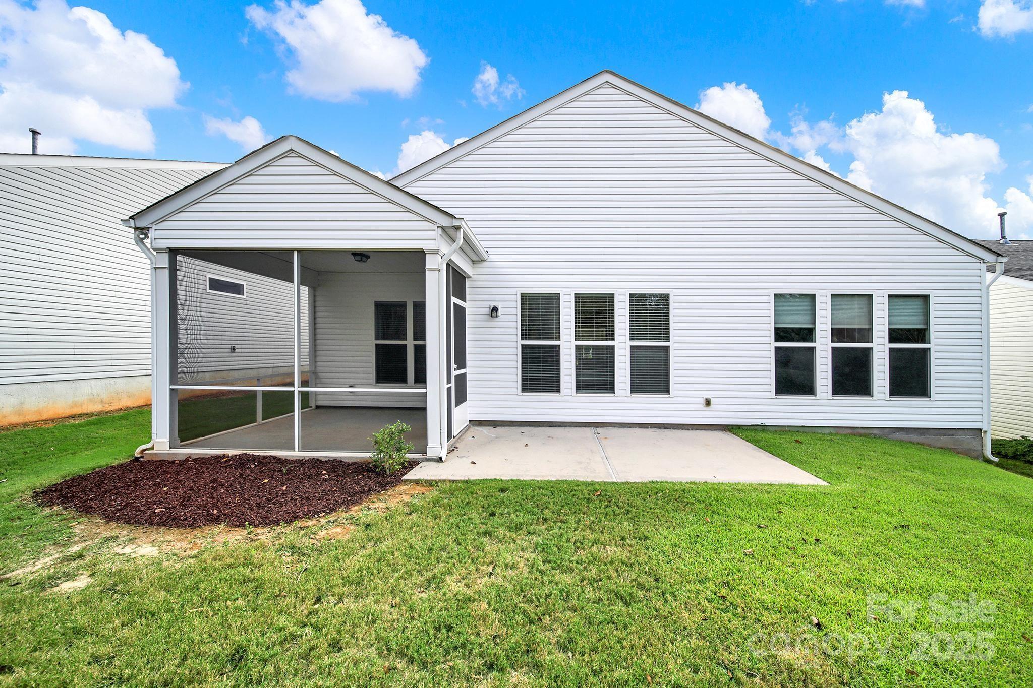 2034 Moultrie Court Fort Mill, SC 29707 - Photo 33 of 46 a view of a house with a garden and yard