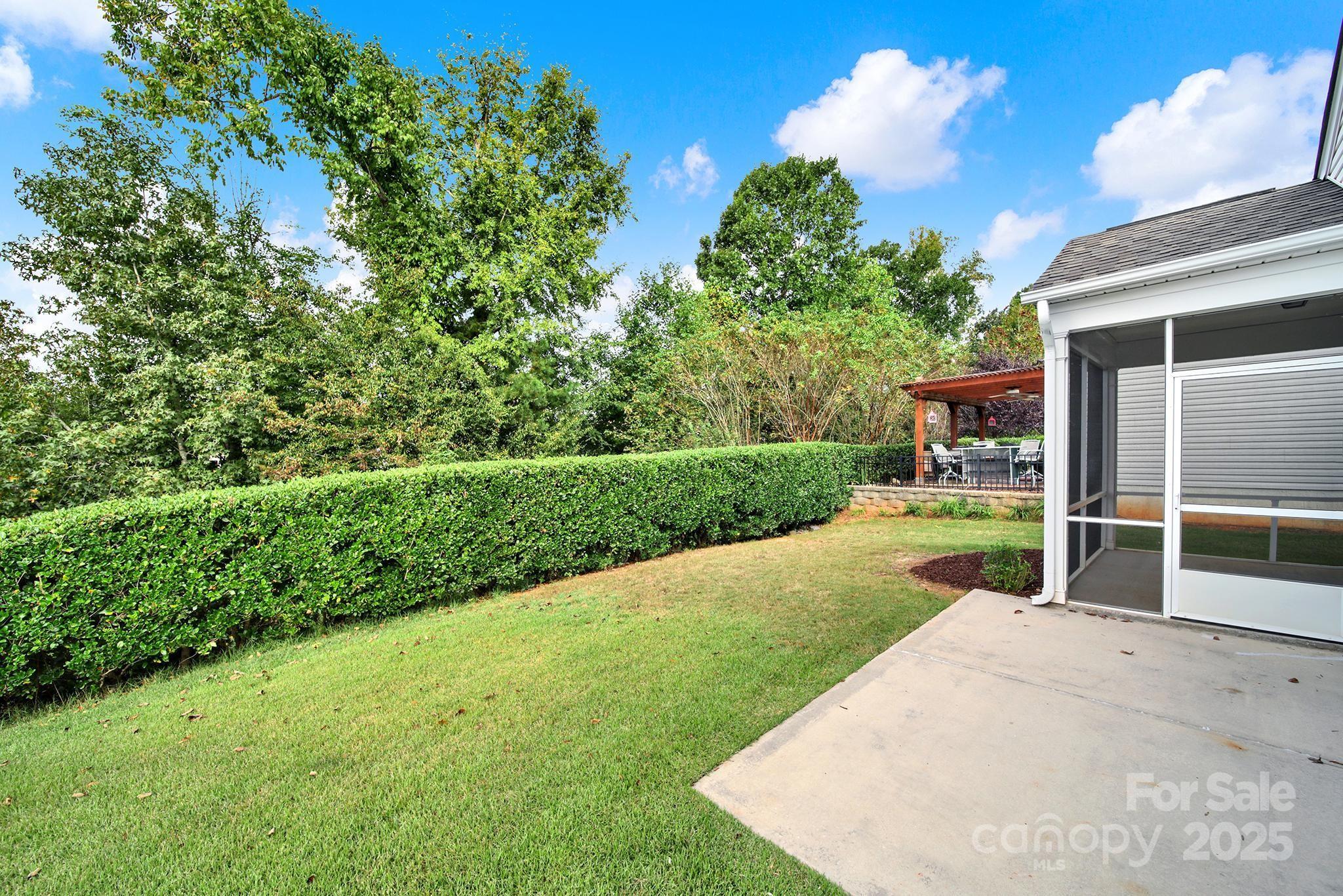 2034 Moultrie Court Fort Mill, SC 29707 - Photo 34 of 46 a view of a backyard with couches plants and large tree