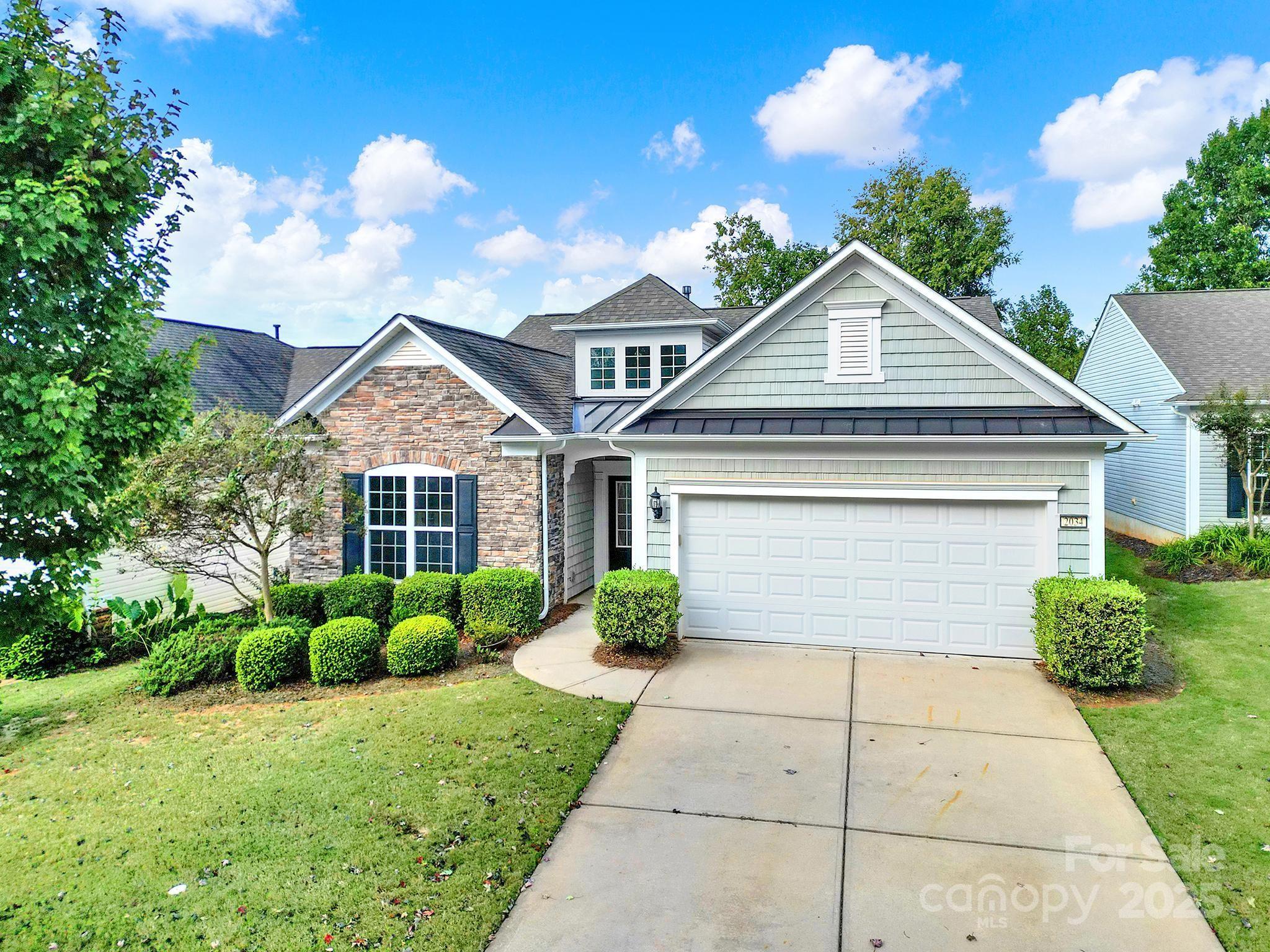 2034 Moultrie Court Fort Mill, SC 29707 - Photo 37 of 46 a front view of a house with garden