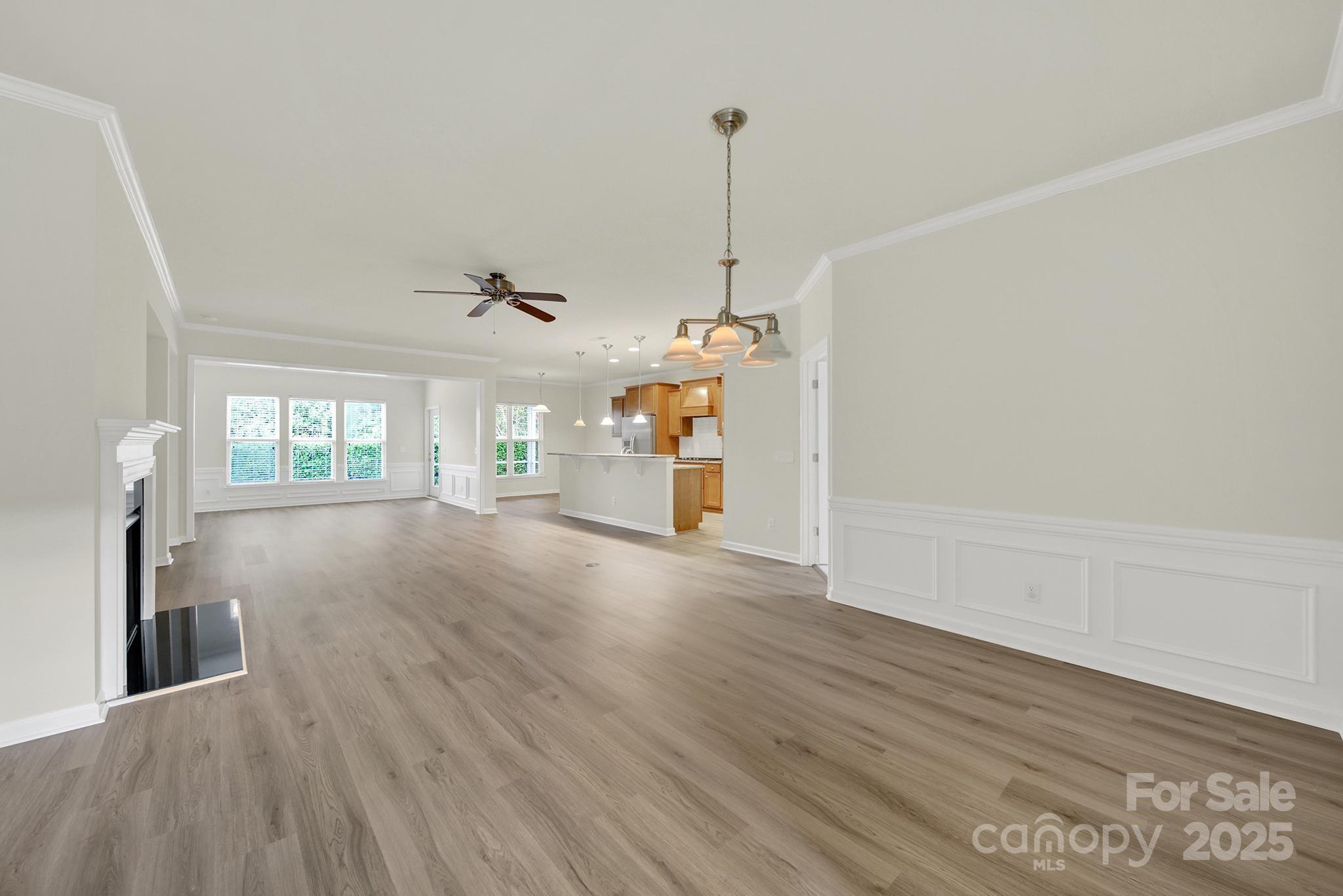 2034 Moultrie Court Fort Mill, SC 29707 - Photo 5 of 46 a view of a room with wooden floor ceiling fan and window