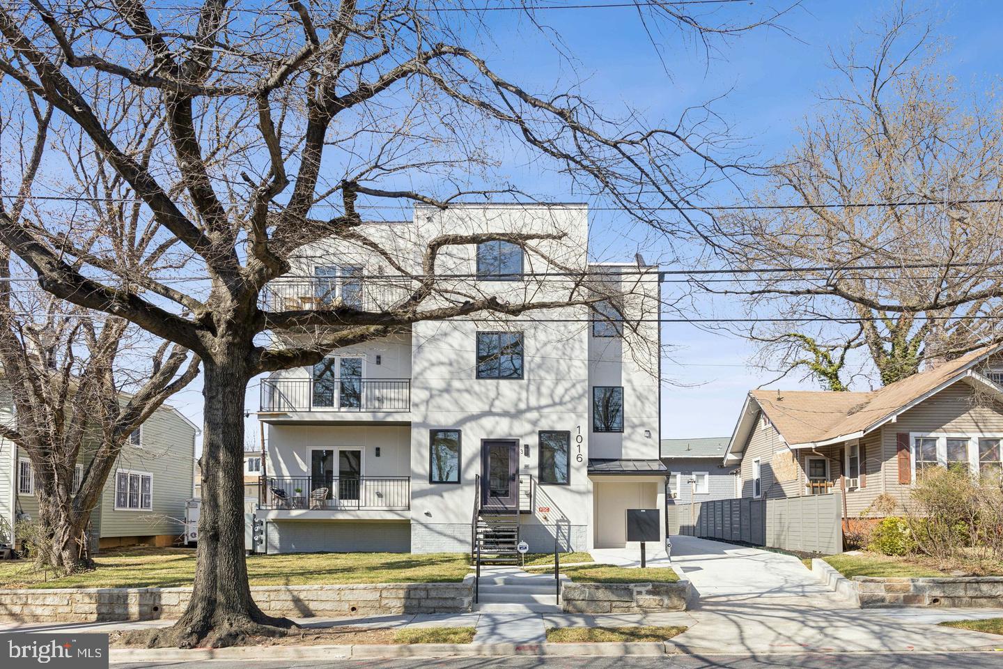 1016 Rhode Island Avenue Northeast, Unit 5 Washington, DC 20018 - Photo 1 of 14 a front view of a building with large trees