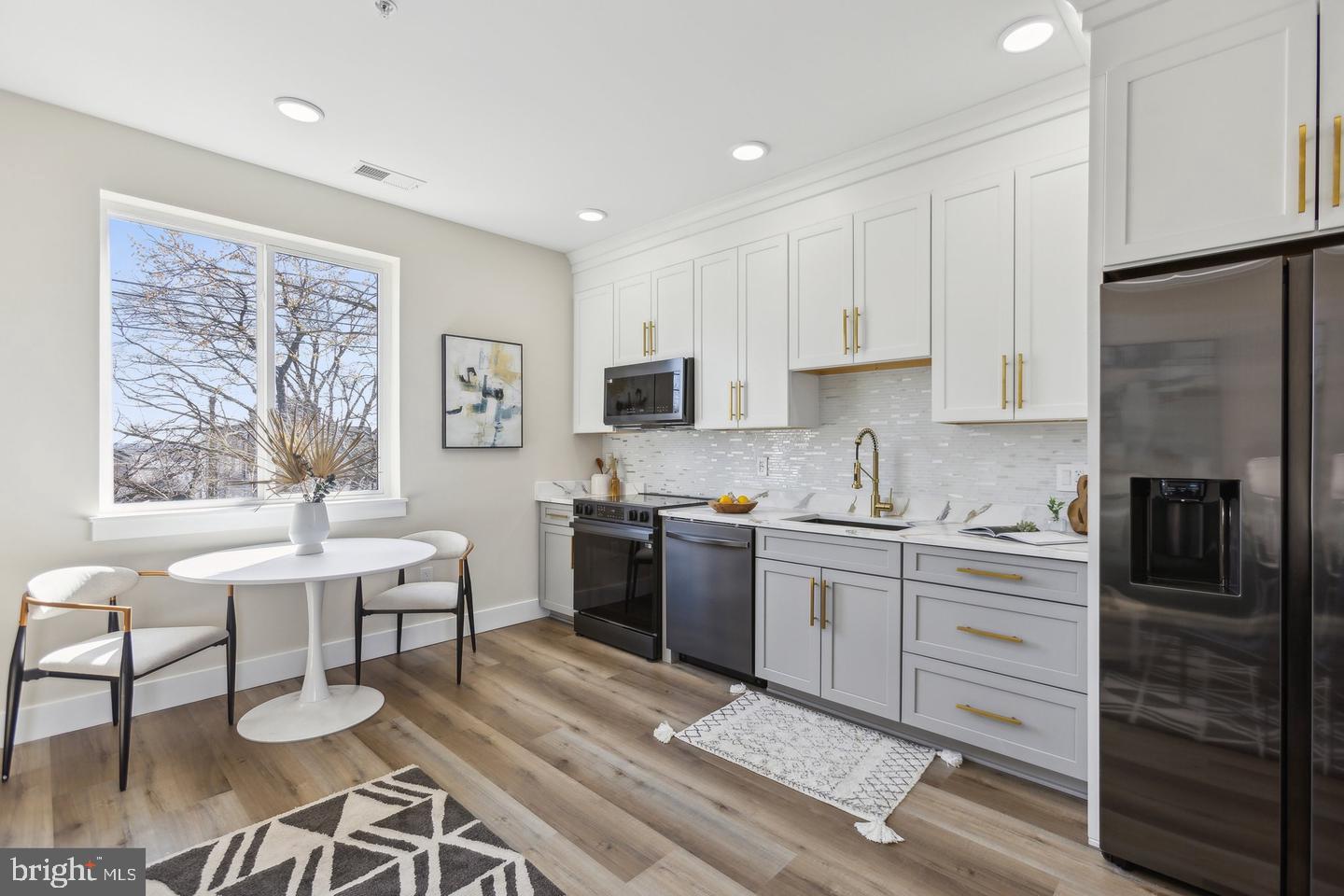 1016 Rhode Island Avenue Northeast, Unit 5 Washington, DC 20018 - Photo 8 of 14 a kitchen with a refrigerator and a stove top oven