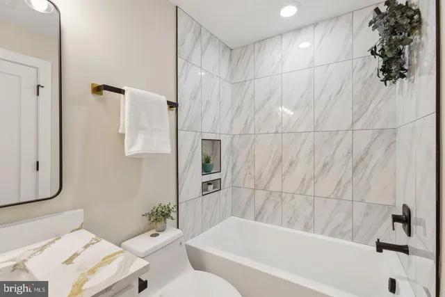 a bathroom with a bathtub and shower