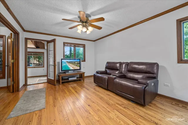 a kitchen with a table chairs refrigerator and microwave