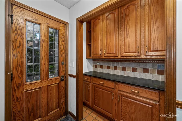 a kitchen with stainless steel appliances granite countertop a refrigerator and a stove