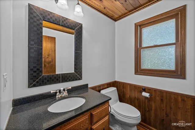 a reading room with wooden floor and a window