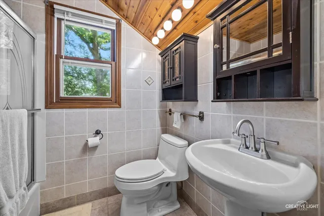 a spacious bedroom with a bed and a dresser