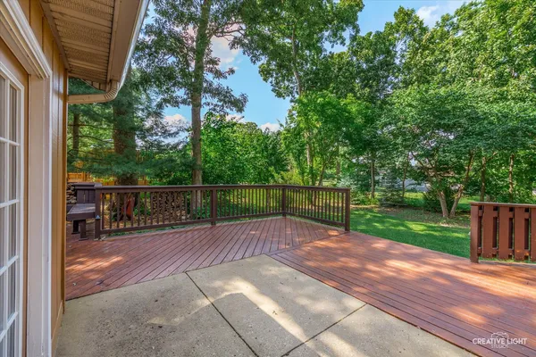 a view of a deck with wooden floor and barbeque oven