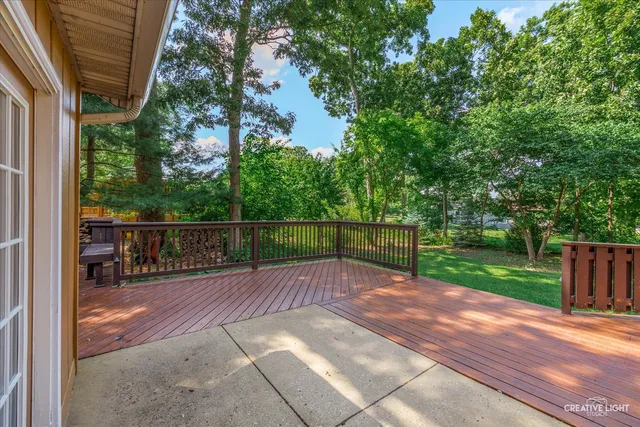 a view of a deck with wooden floor and barbeque oven
