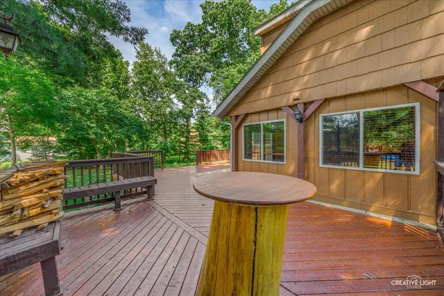 a view of a house with a big yard plants and large trees