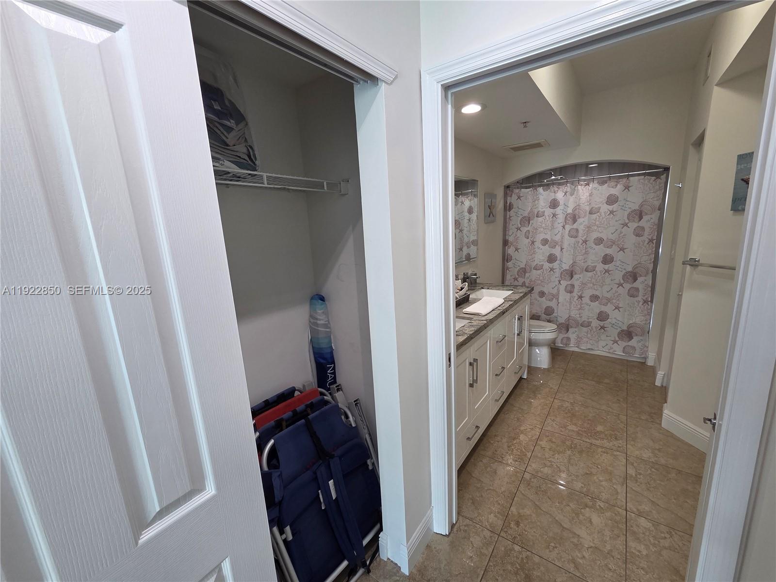 9172 Collins Avenue, Unit 403 Surfside, FL 33154 - Photo 13 of 24 a bathroom with a toilet sink and a shower