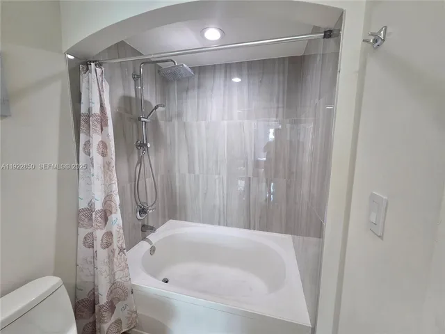 a bathroom with a tub and a sink