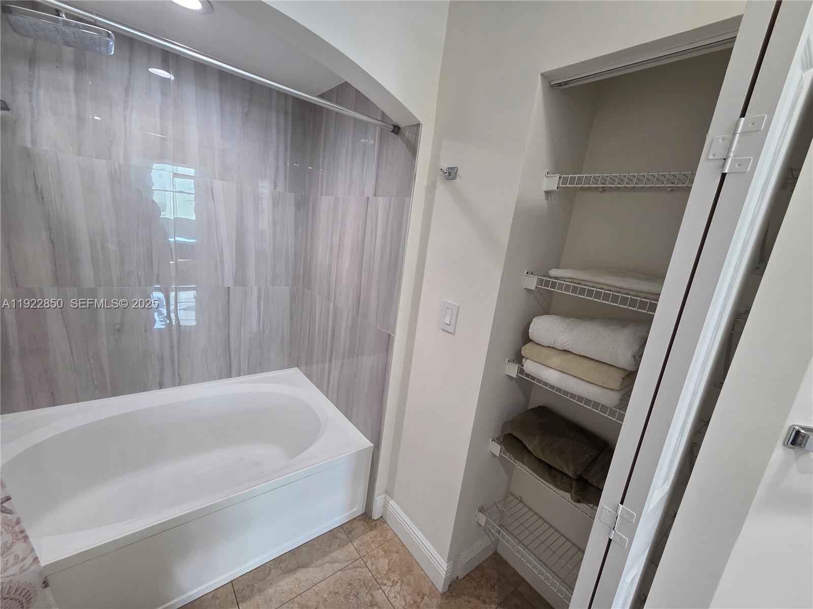 9172 Collins Avenue, Unit 403 Surfside, FL 33154 - Photo 15 of 24 a bathroom with a tub and a sink