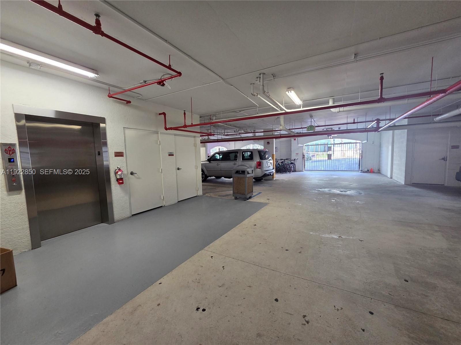 9172 Collins Avenue, Unit 403 Surfside, FL 33154 - Photo 18 of 24 a view of parking garage with cars
