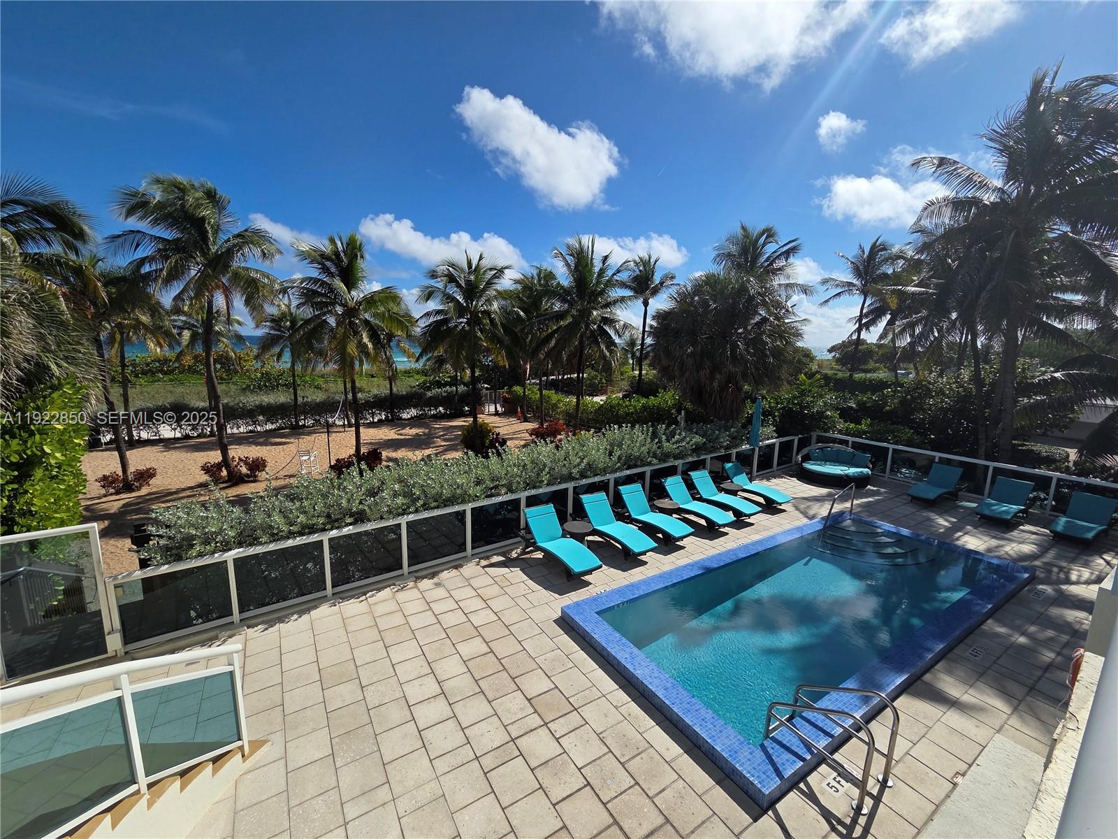 9172 Collins Avenue, Unit 403 Surfside, FL 33154 - Photo 20 of 24 a view of a chairs and table in the patio