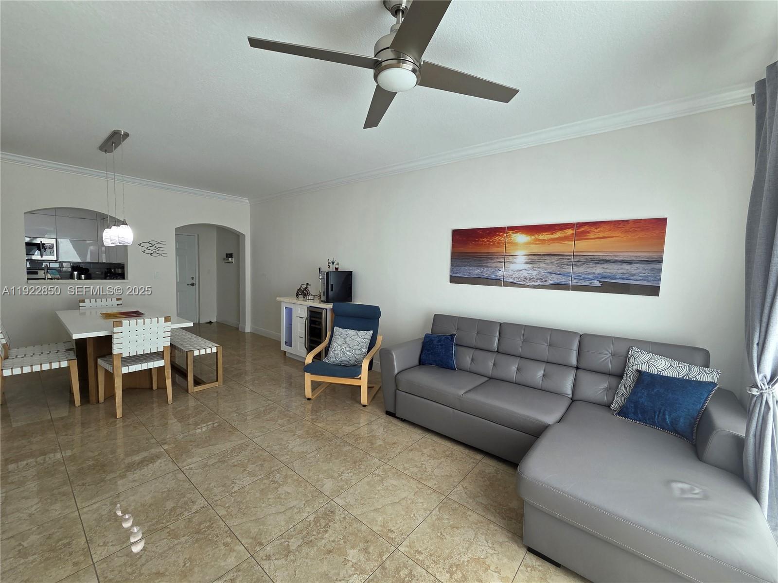 9172 Collins Avenue, Unit 403 Surfside, FL 33154 - Photo 3 of 24 a living room with furniture a rug and white walls