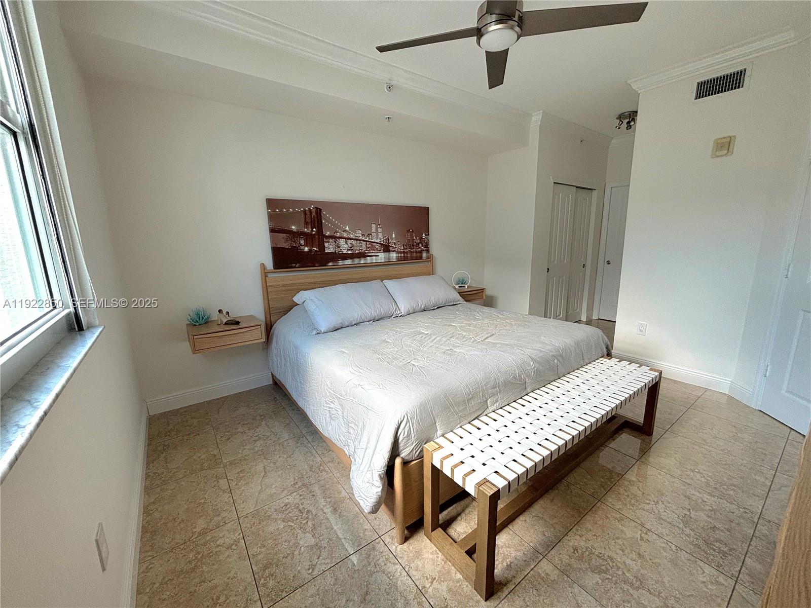 9172 Collins Avenue, Unit 403 Surfside, FL 33154 - Photo 8 of 24 a bedroom with a bed and a window