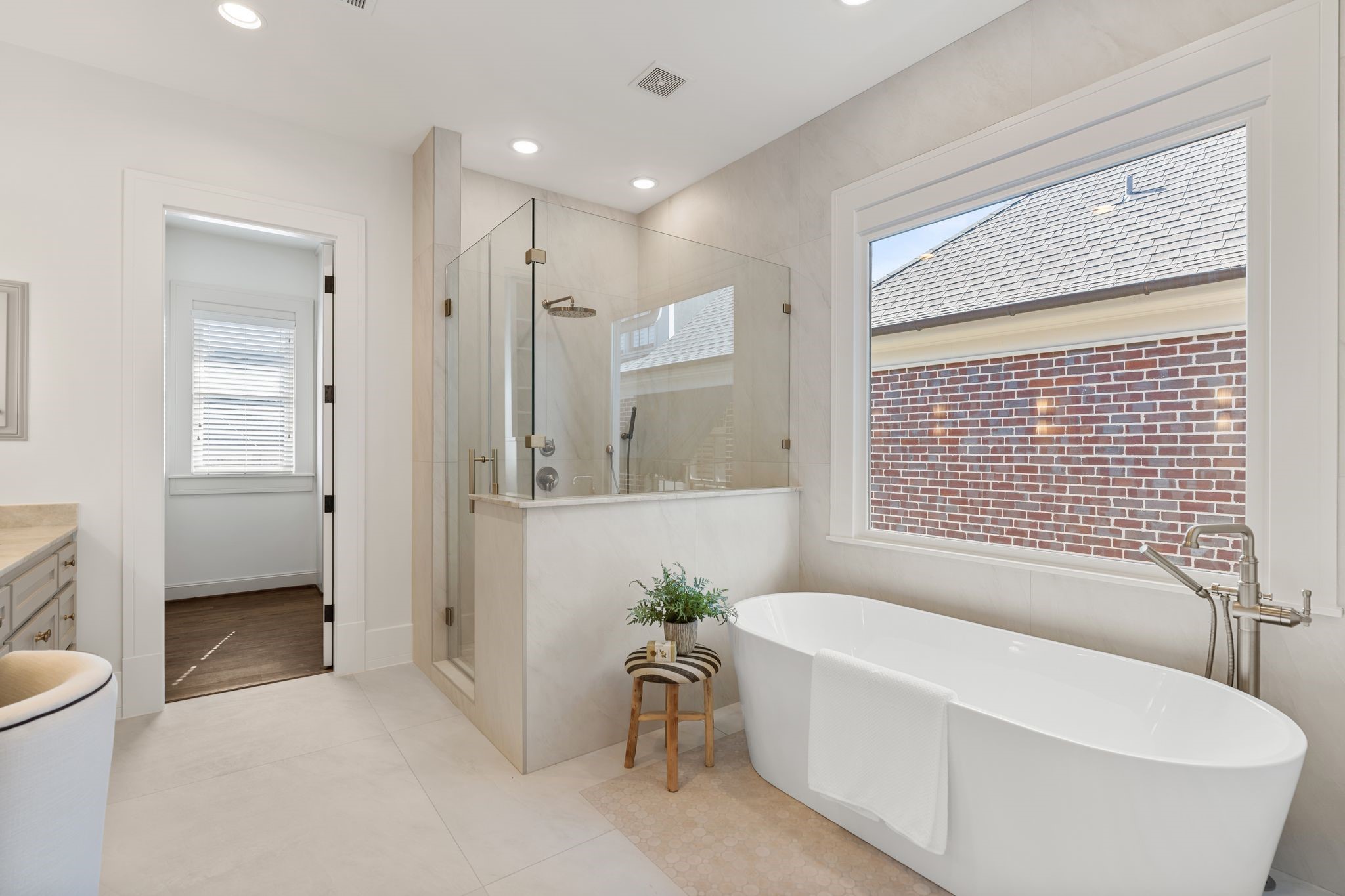 1815 Milford Street Houston, TX 77098 - Photo 16 of 33 BATHROOM III - Large walk-in shower with frameless glass and separate freestanding tub. Window provides tons of natural light.