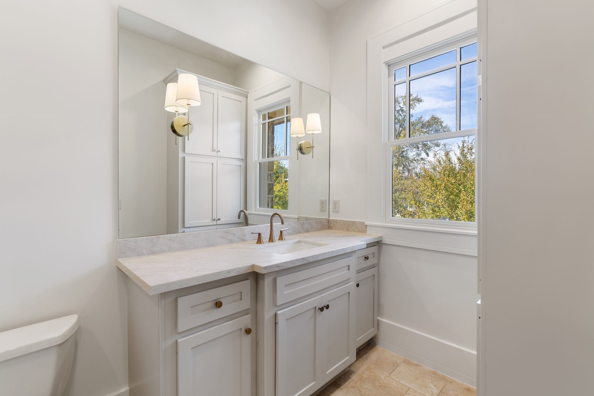 1815 Milford Street Houston, TX 77098 - Photo 19 of 33 SECONDARY BATHROOM I - En-suite bathroom with quartz countertops and stone flooring.