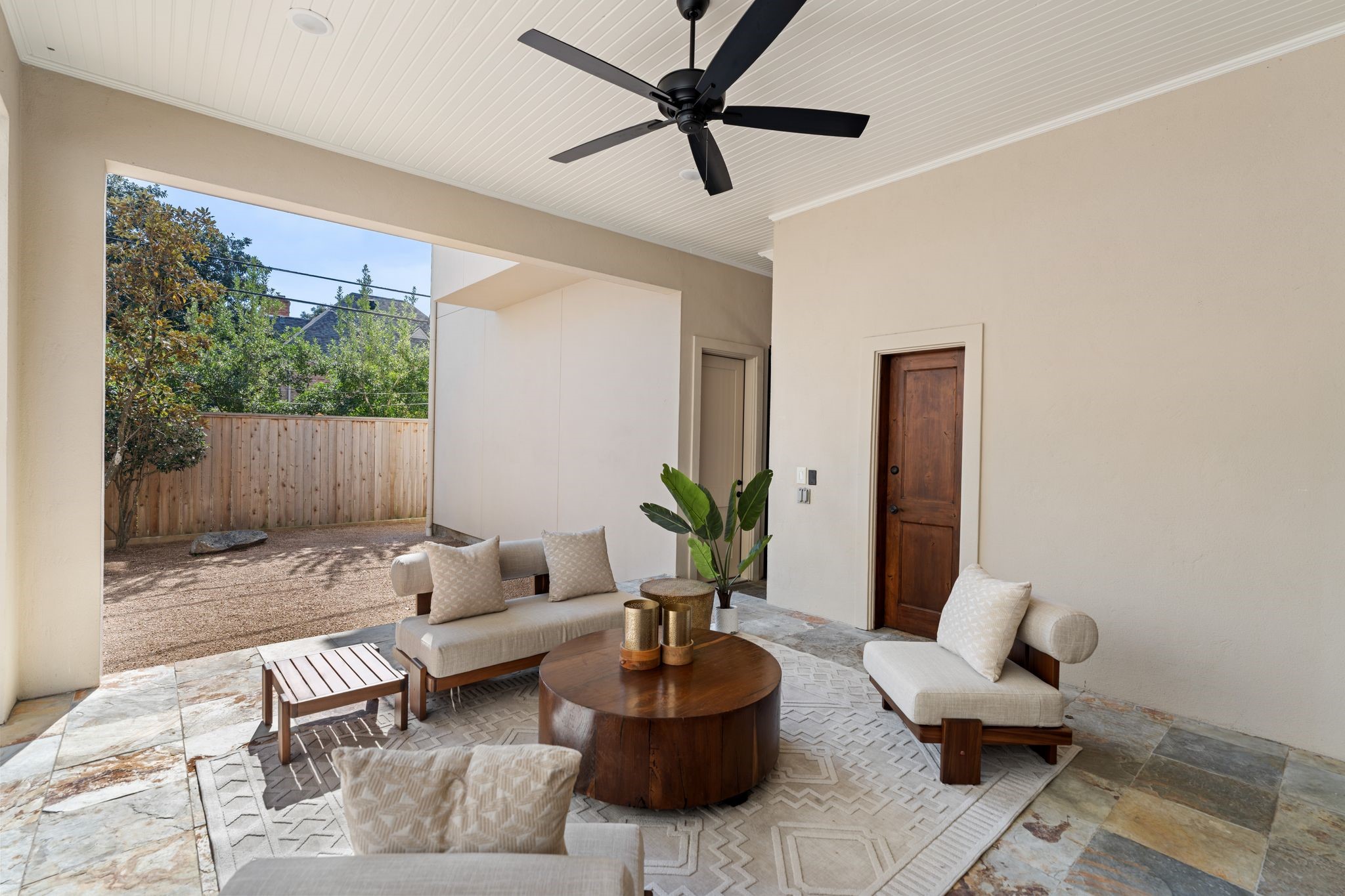 1815 Milford Street Houston, TX 77098 - Photo 31 of 33 Spacious covered patio with a fan and beadboard ceiling. Door leads to outdoor powder room.