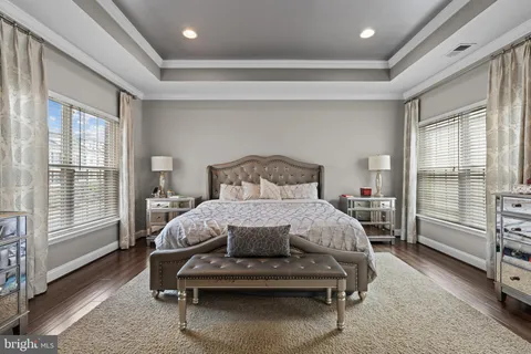 a bedroom with a bed a table and with a large window