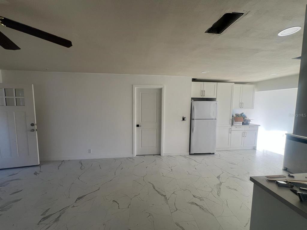 132 Miller Drive Winter Haven, FL 33884 - Photo 8 of 15 a view of a refrigerator and window in a kitchen