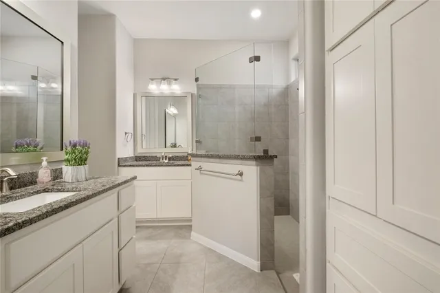 a bathroom with a double vanity sink and a mirror