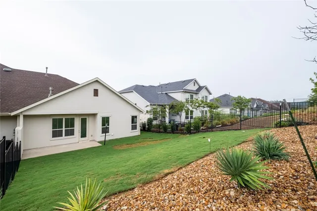 a view of a house with a yard and porch