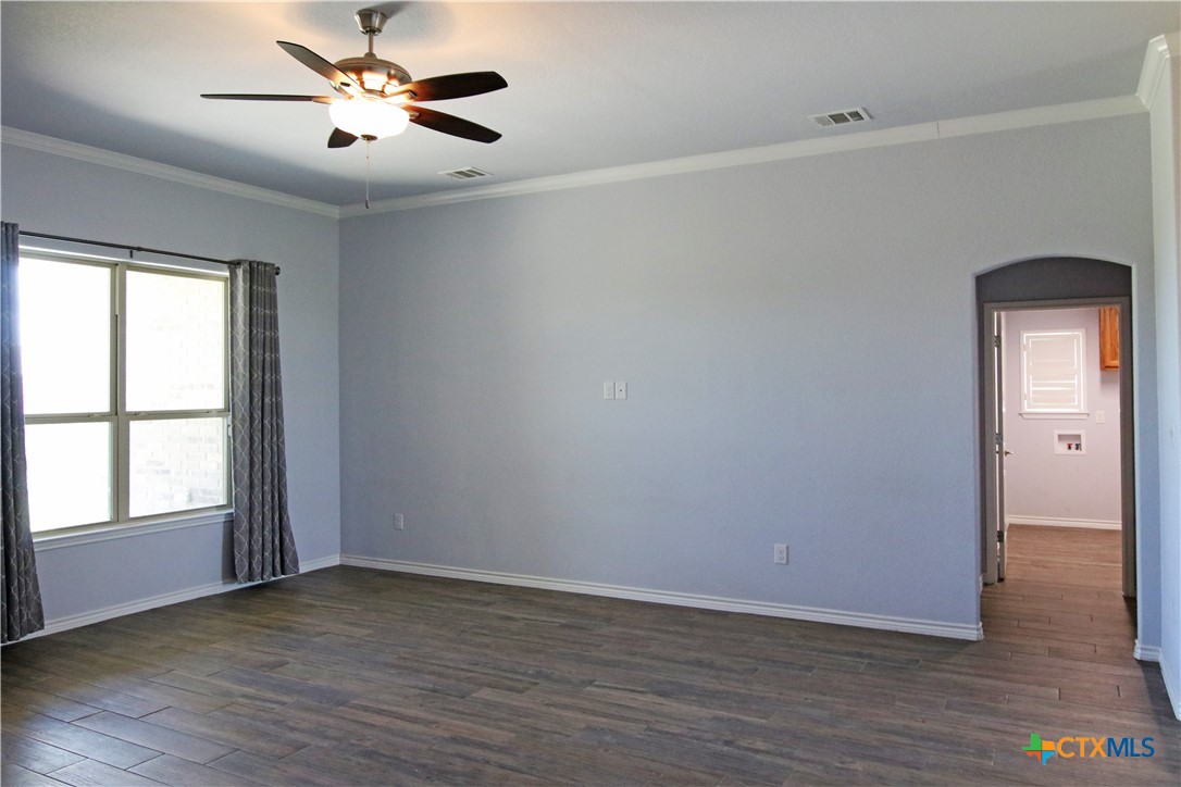 2734 Rock Road Troy, TX 76579 - Photo 13 of 48 an empty room with wooden floor cabinet and windows