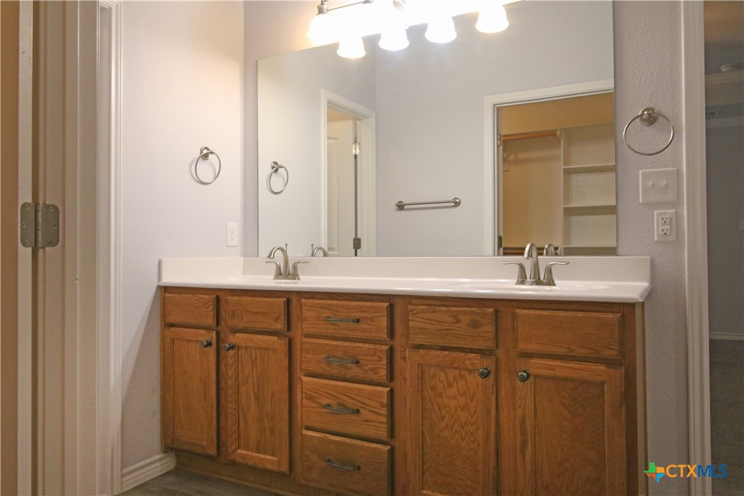 2734 Rock Road Troy, TX 76579 - Photo 17 of 48 a bathroom with a double vanity sink and a mirror