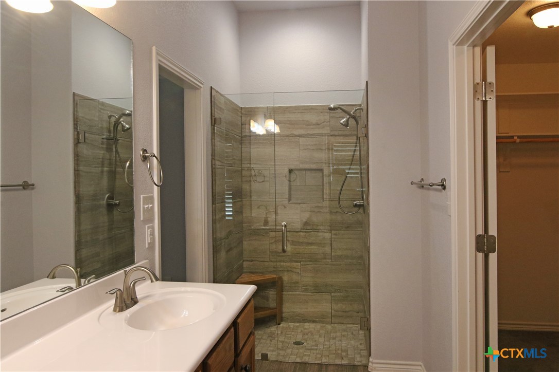 2734 Rock Road Troy, TX 76579 - Photo 18 of 48 a bathroom with a sink shower and a mirror