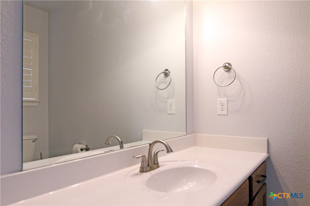 2734 Rock Road Troy, TX 76579 - Photo 31 of 48 a bathroom with a sink and mirror