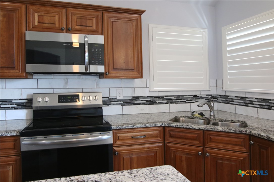 2734 Rock Road Troy, TX 76579 - Photo 6 of 48 a kitchen with stainless steel appliances granite countertop a sink and a stove