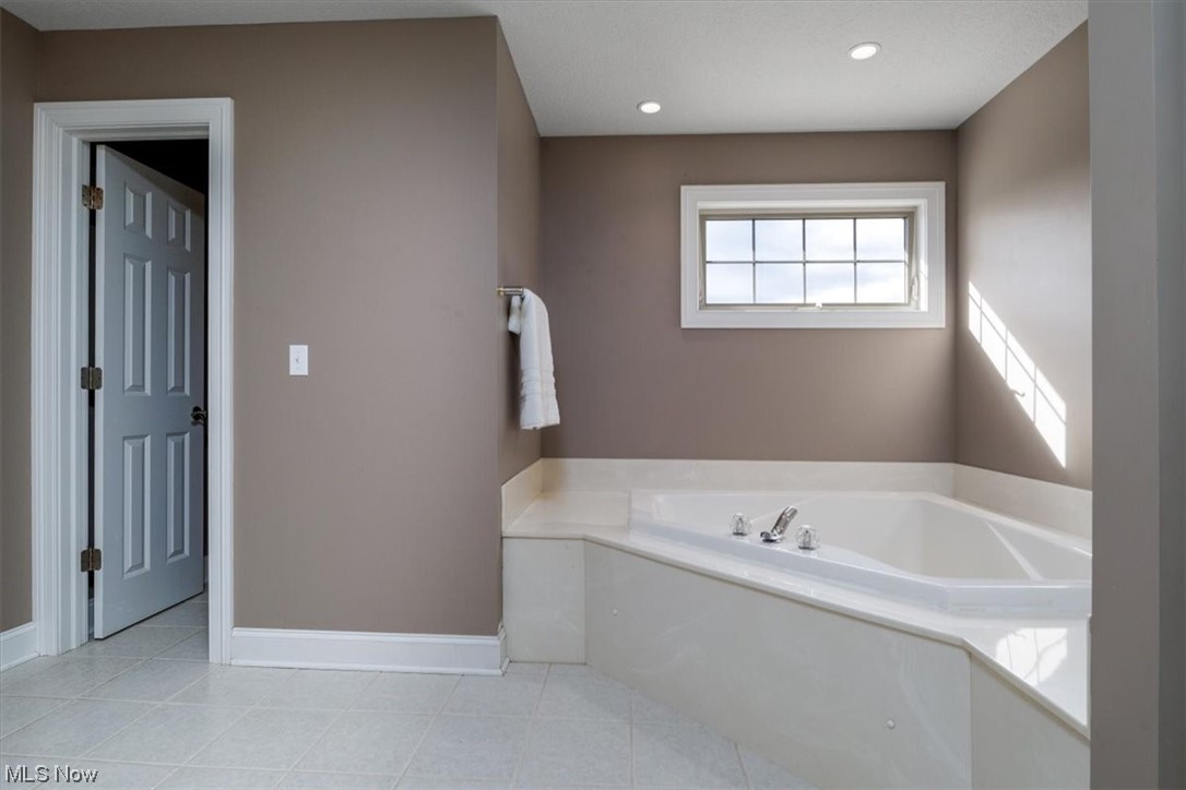 514 Silver Ridge Drive Akron, OH 44321 - Photo 23 of 47 The primary Bathroom has a lovely soaking tub and private commode room.