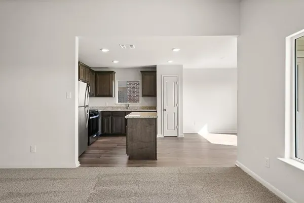 a kitchen with a refrigerator and a sink