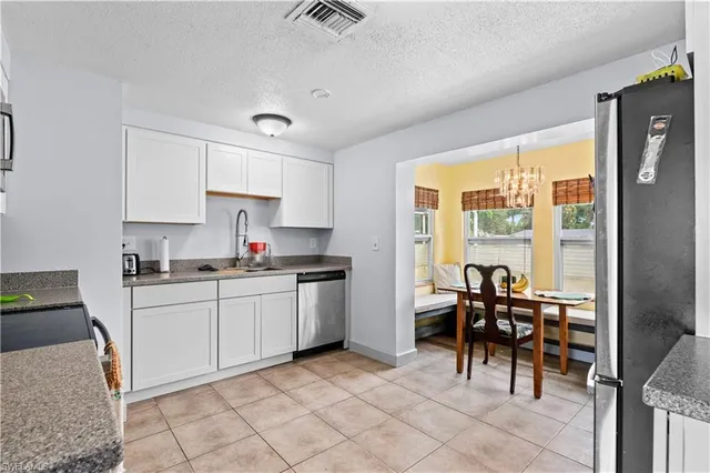a kitchen with granite countertop sink cabinets and stainless steel appliances